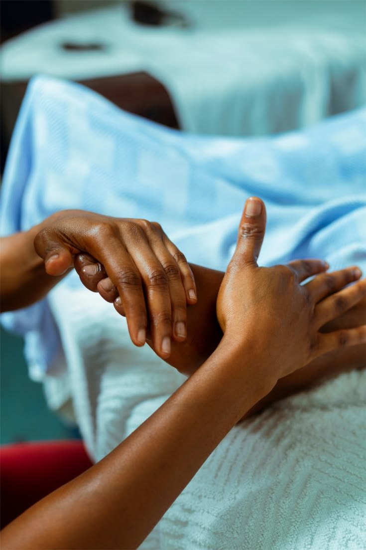 Therapist performing a Swedish massage on a client's hand and forearm at Blossoms Massage Spa, Kilimani